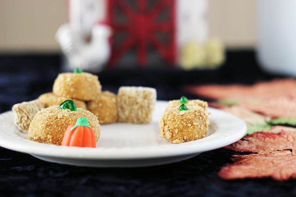 Pumpkin treats on a plate in front of a barn decoration. 