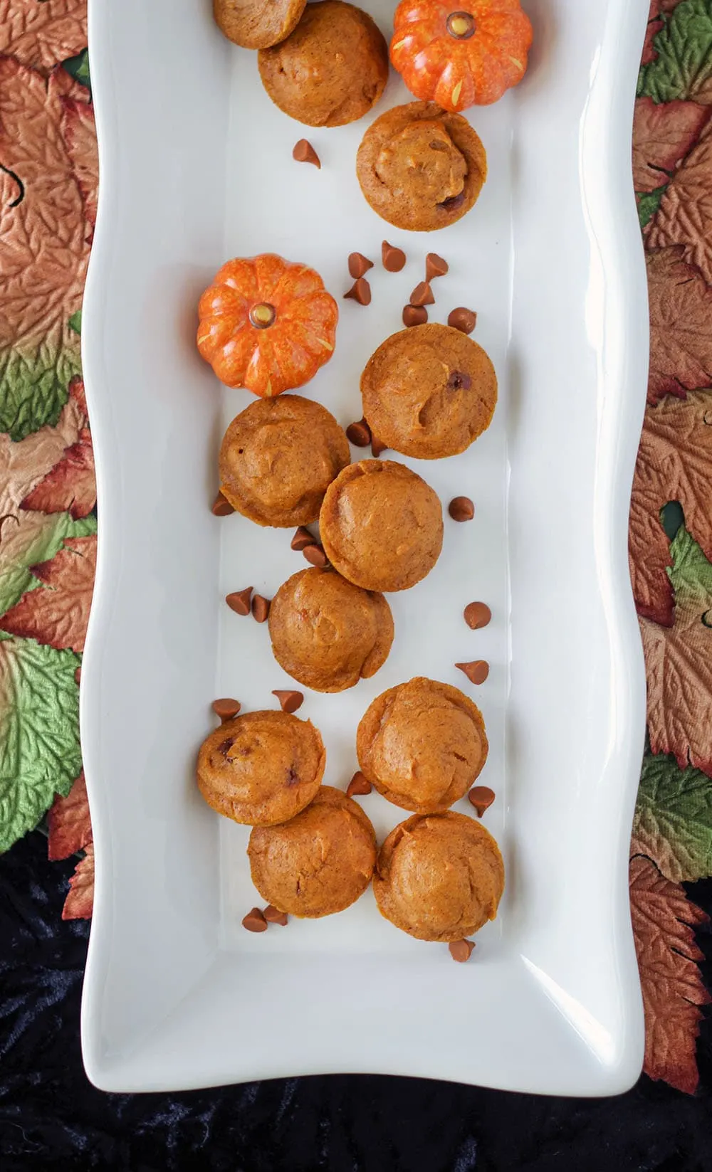 Pumpkin mini cakes on a tray with cinnamon chips. 