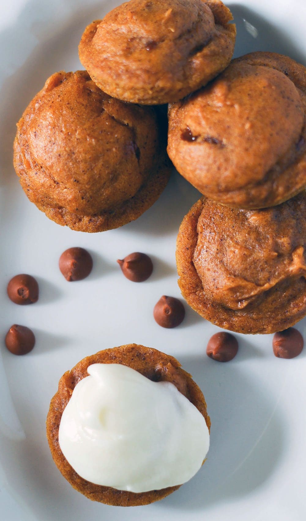 Tiny pumpkin cakes with chips and frosting.