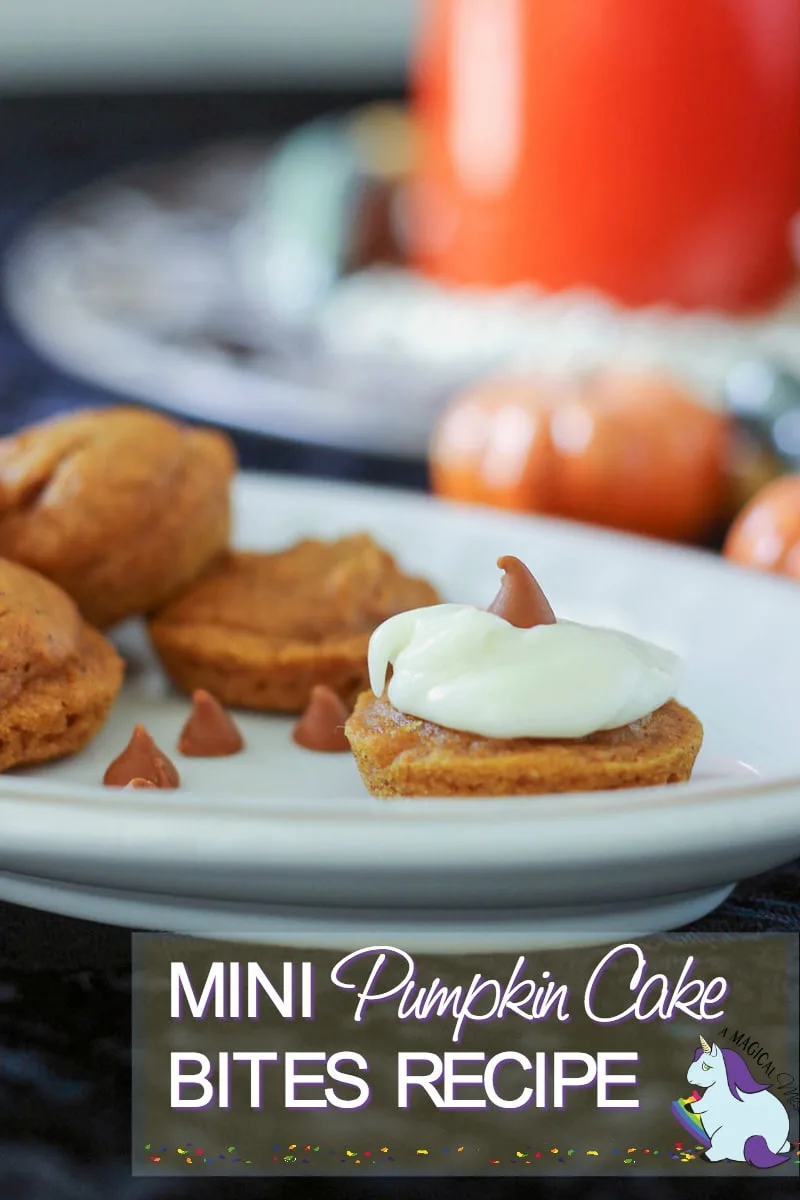 Little pumpkin cakes on a tray with pumpkin decor in the background.