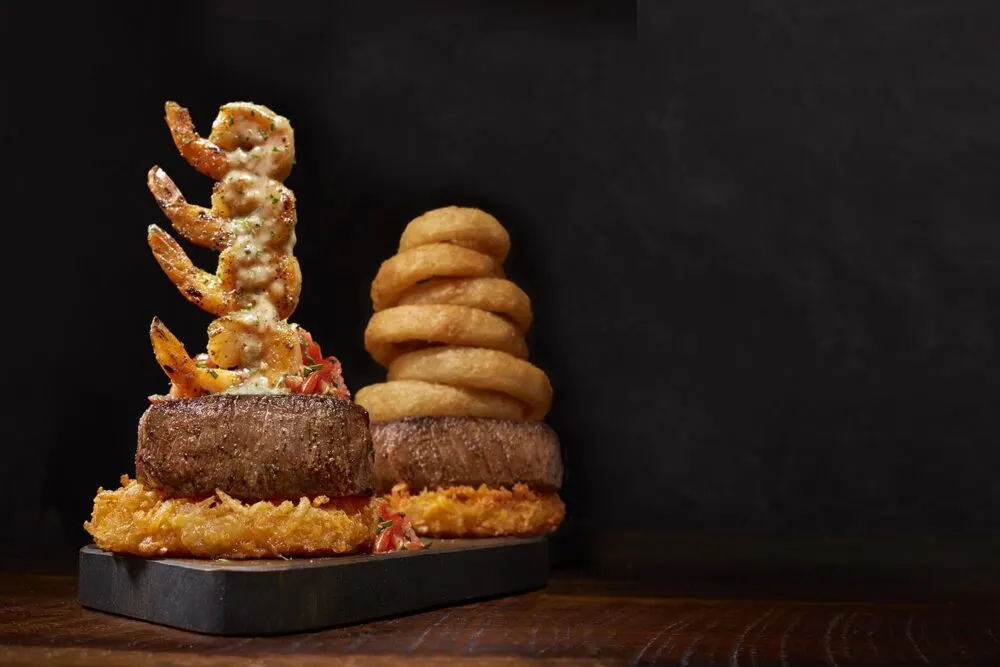 Steak with shrimp and onion rings. 