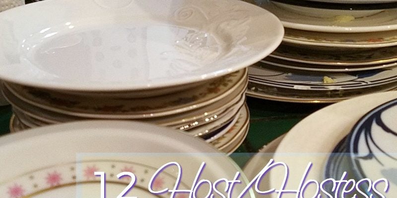 Piles and piles of dishes next to a sink.