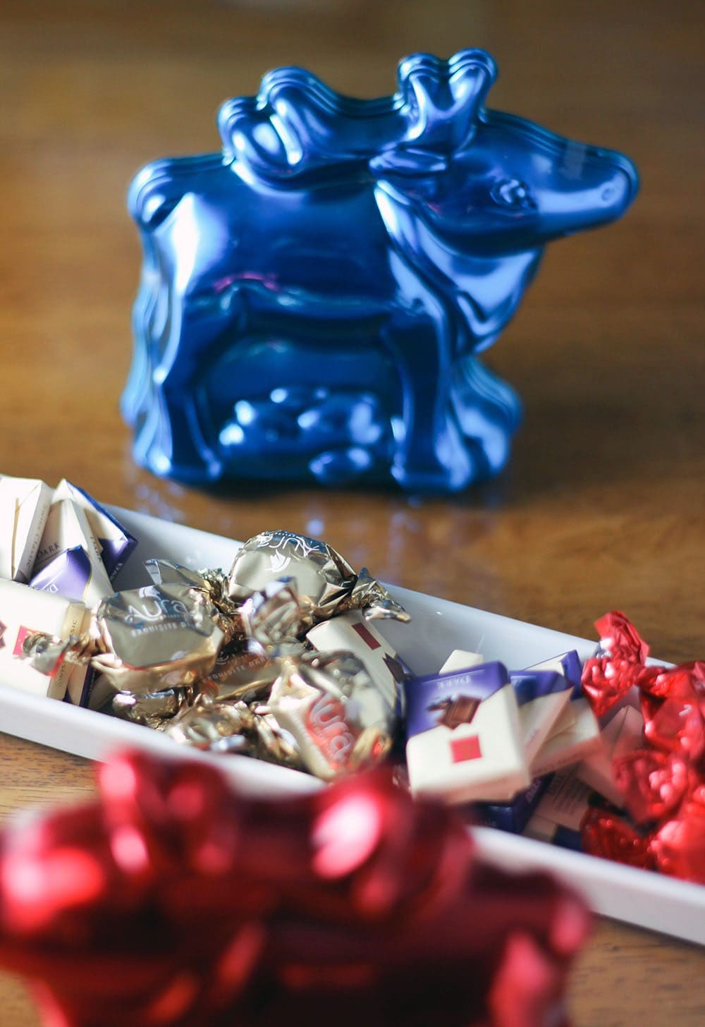 Blue reindeer candy and pieces of Frey chocolates in a dish. 