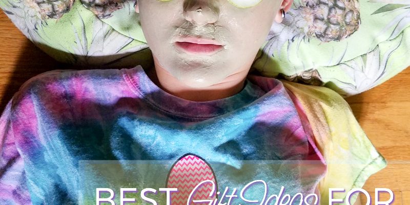 Tween girl laying on a pillow with cucumbers on her eyes and a face mask. 