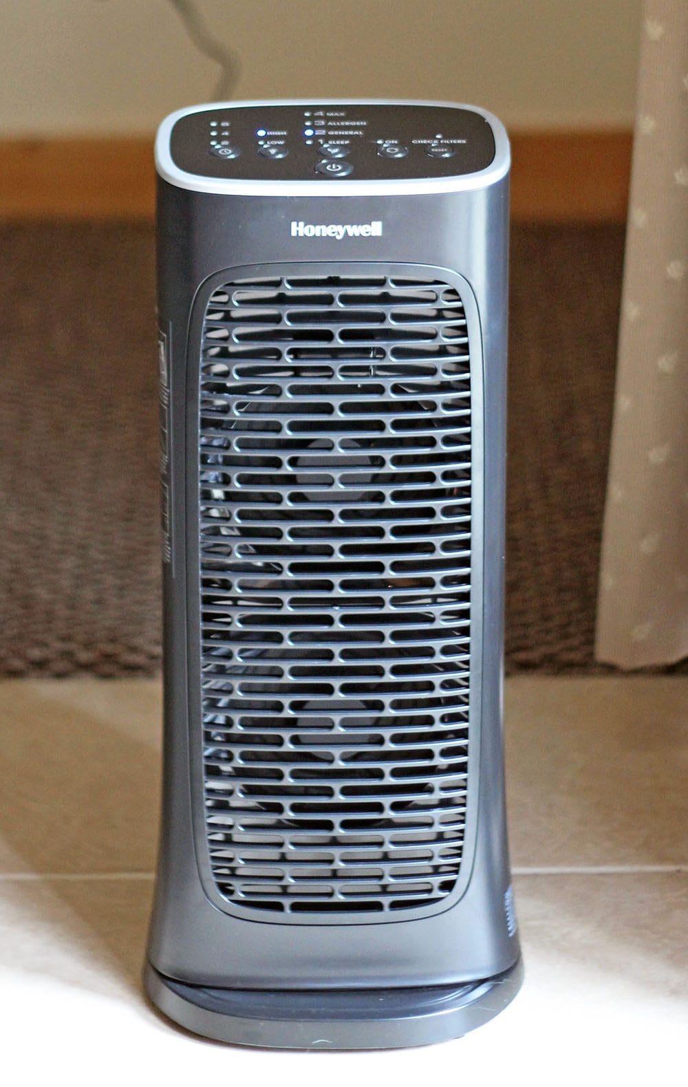 A Honeywell Air Cleaner sitting on tile. 