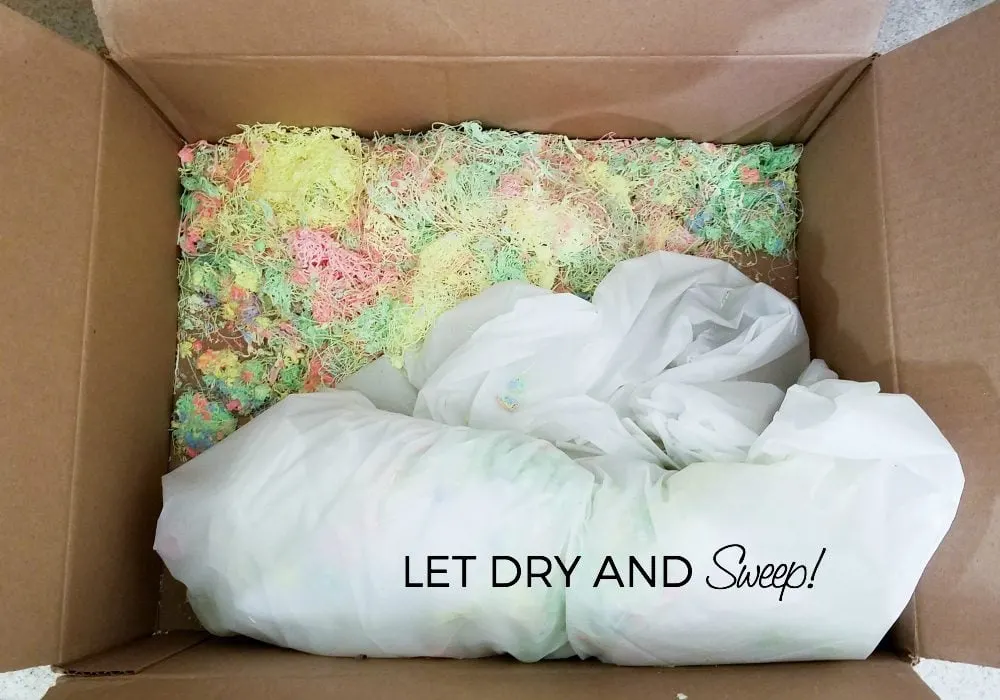 Box of used up silly string and a tablecloth. 