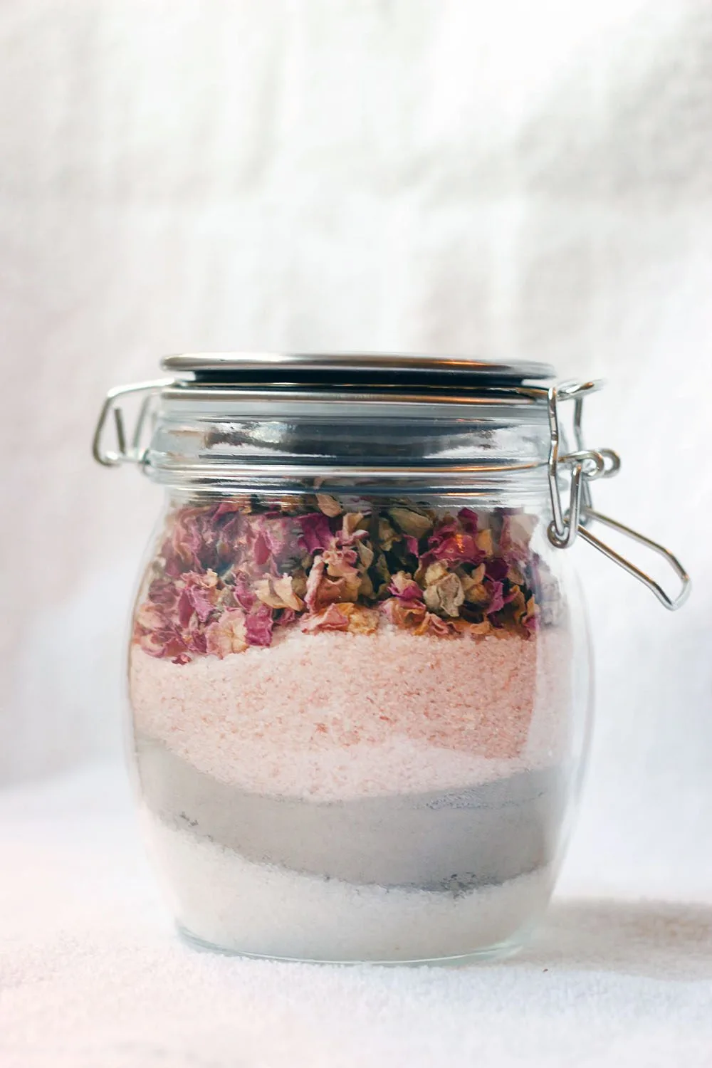 Layered bath soak with rose petals and sea salts.