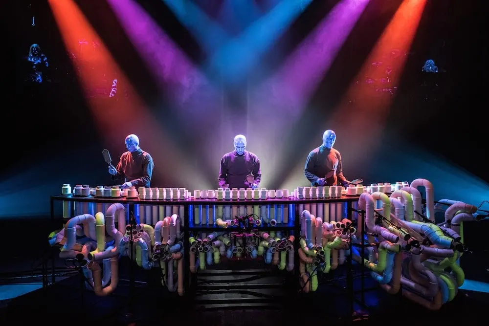 Blue Man Group members on stage. 
