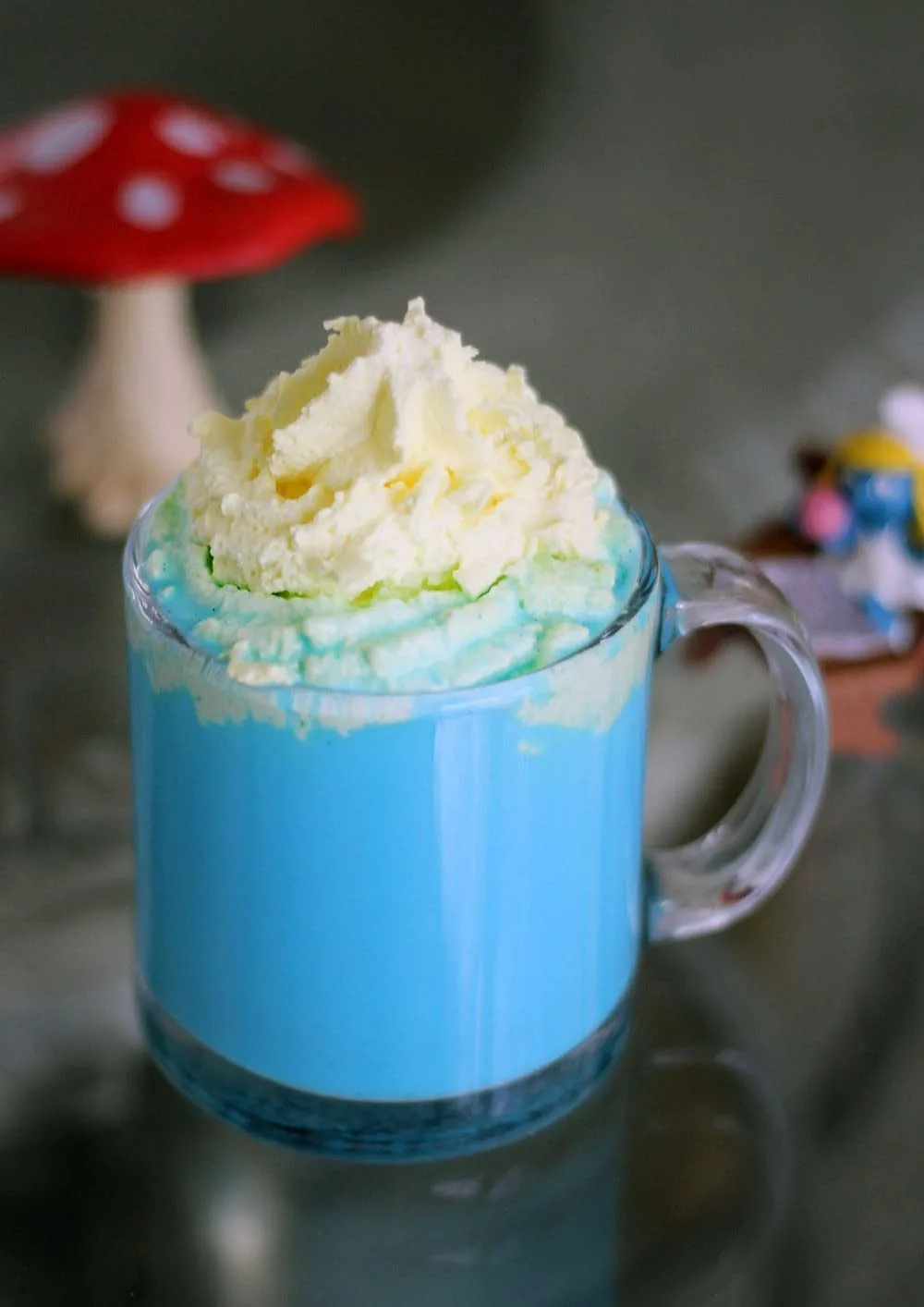 Vanilla Smurfette Blue Drink Recipe in a clear mug. 
