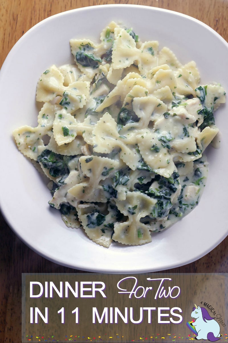 Bowl of bow-tie pasta and a spinach cream sauce. 