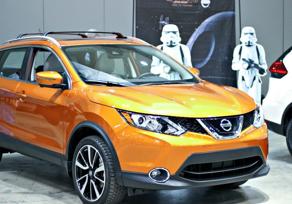 Orange vehicle at the auto show. 