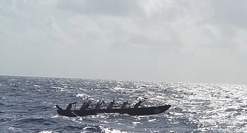 Oarsmen in a canoe in the open ocean during The Sacred Mayan Journey.
