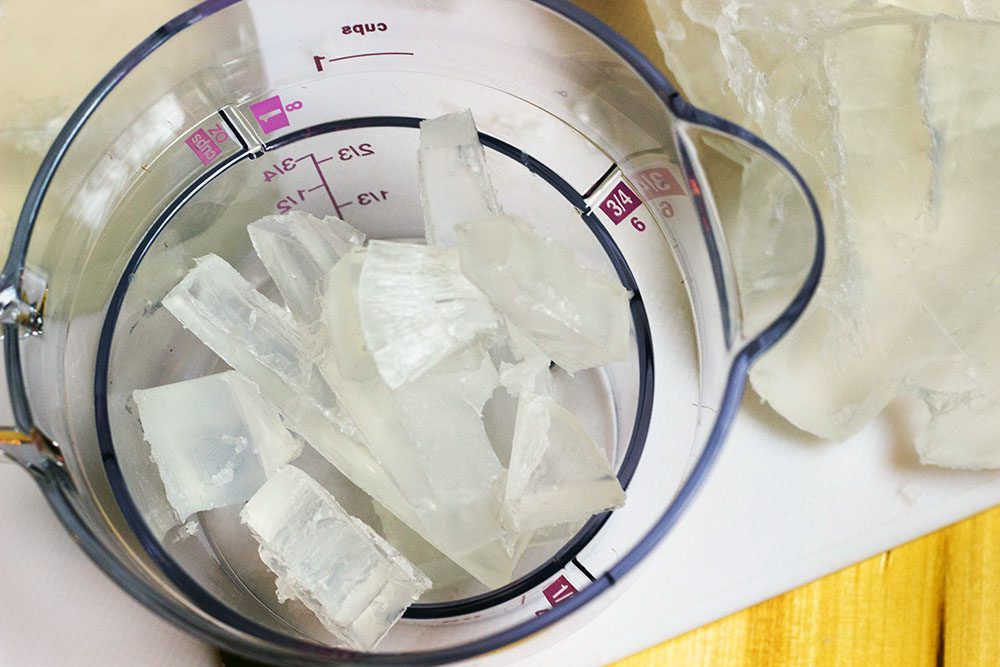 Pieces of clear soap in a measuring cup. 