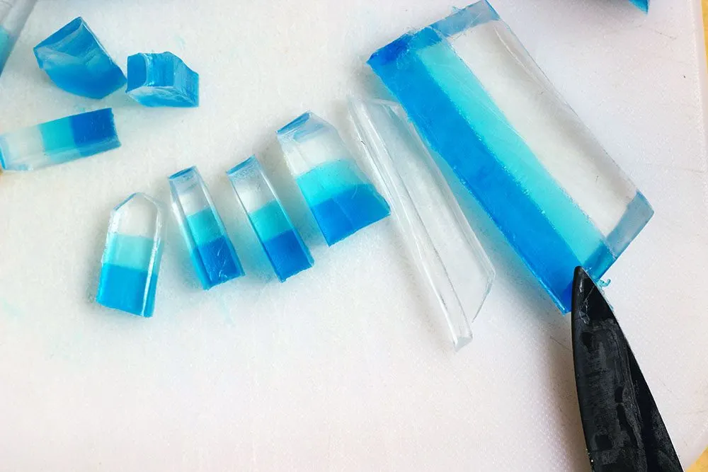 Slicing soap into pieces that look like crystals. 