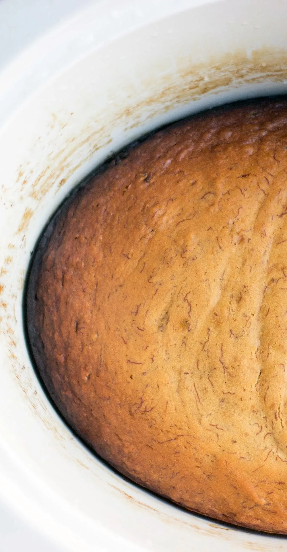 Banana bread in a white crockpot.