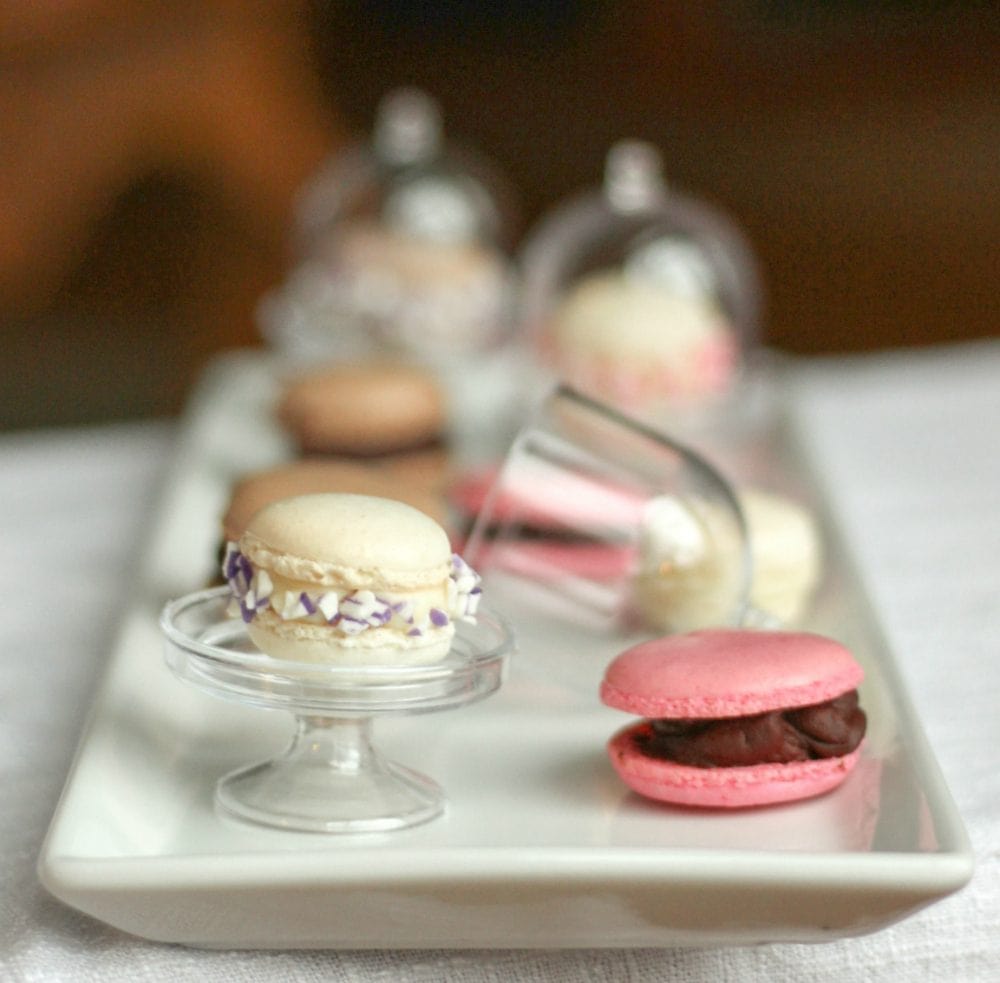 Mini gluten free macarons in different colors on a tray. 