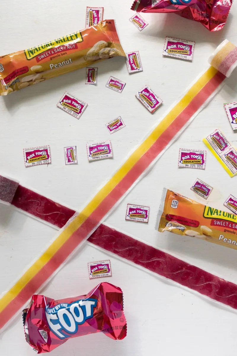 Box tops on a table with snacks. 