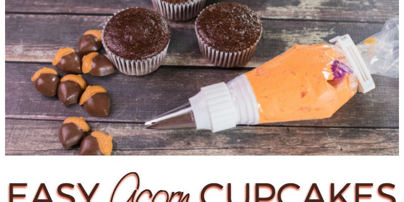 Acorn candy on top of chocolate cupcakes with orange frosting
