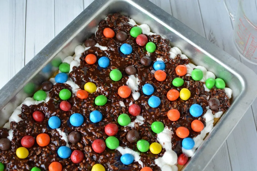 Cookie bar with candy layers in a baking pan.