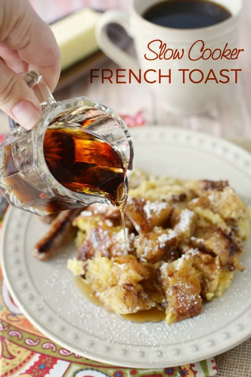 Pouring syrup on a plate of french toast. 