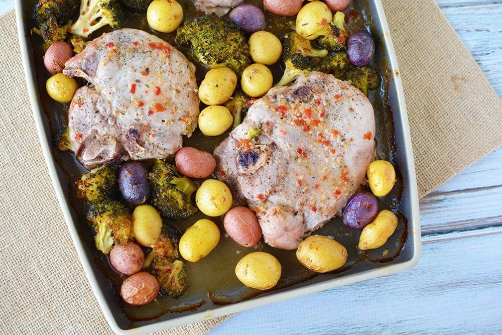 Zesty pork chops on a sheet pan with veggies