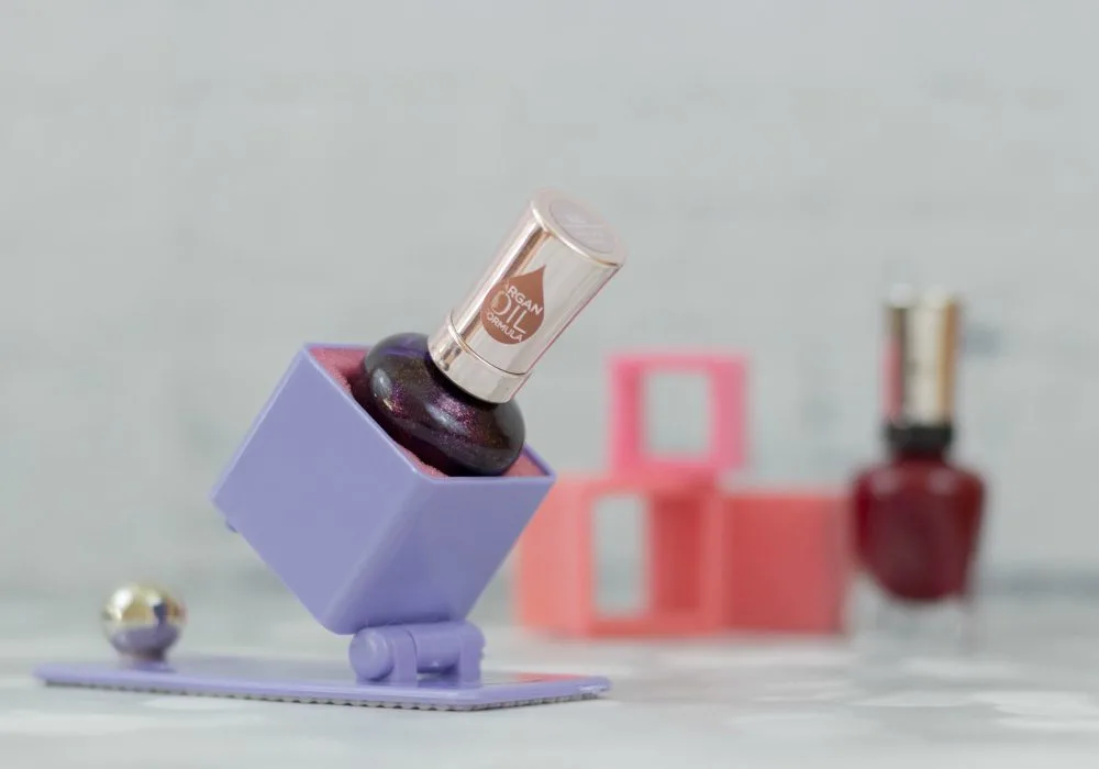 Bottle of nail polish in a tippur nail polish holder. 