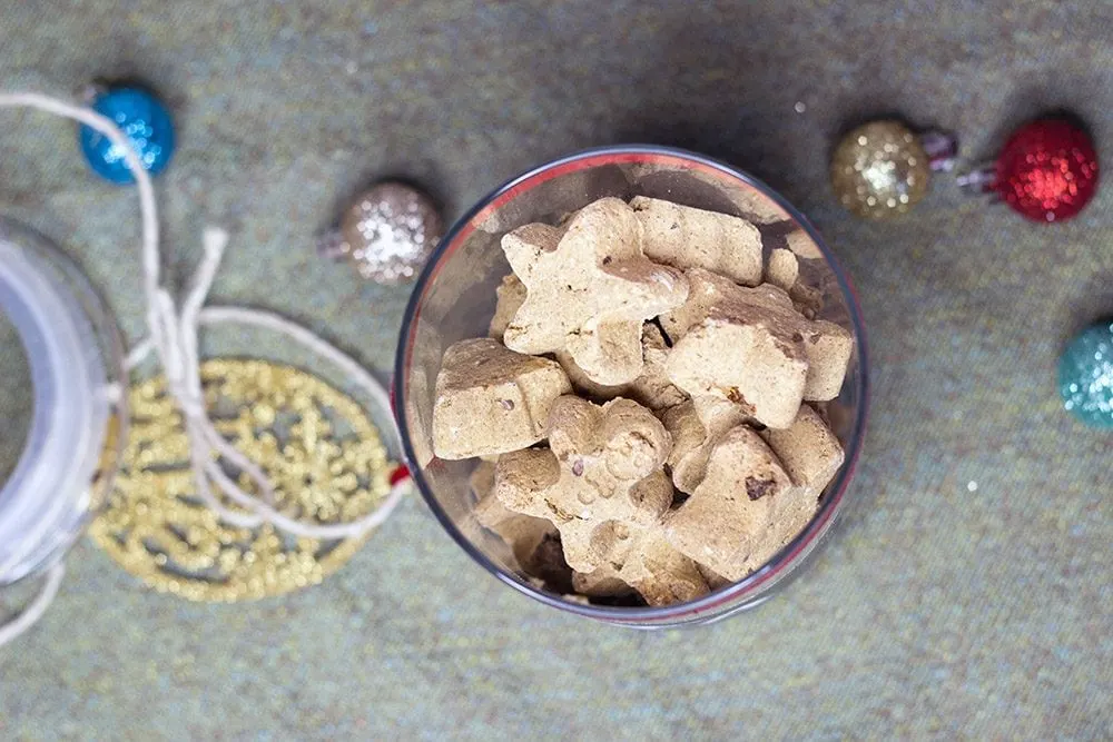 Star treats in a jar next to ornaments and twine. 