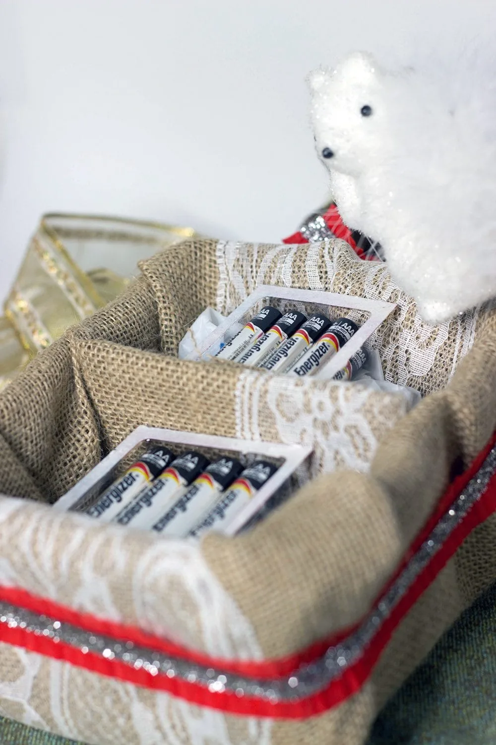 Batteries in a decorated basket with holiday decor. 