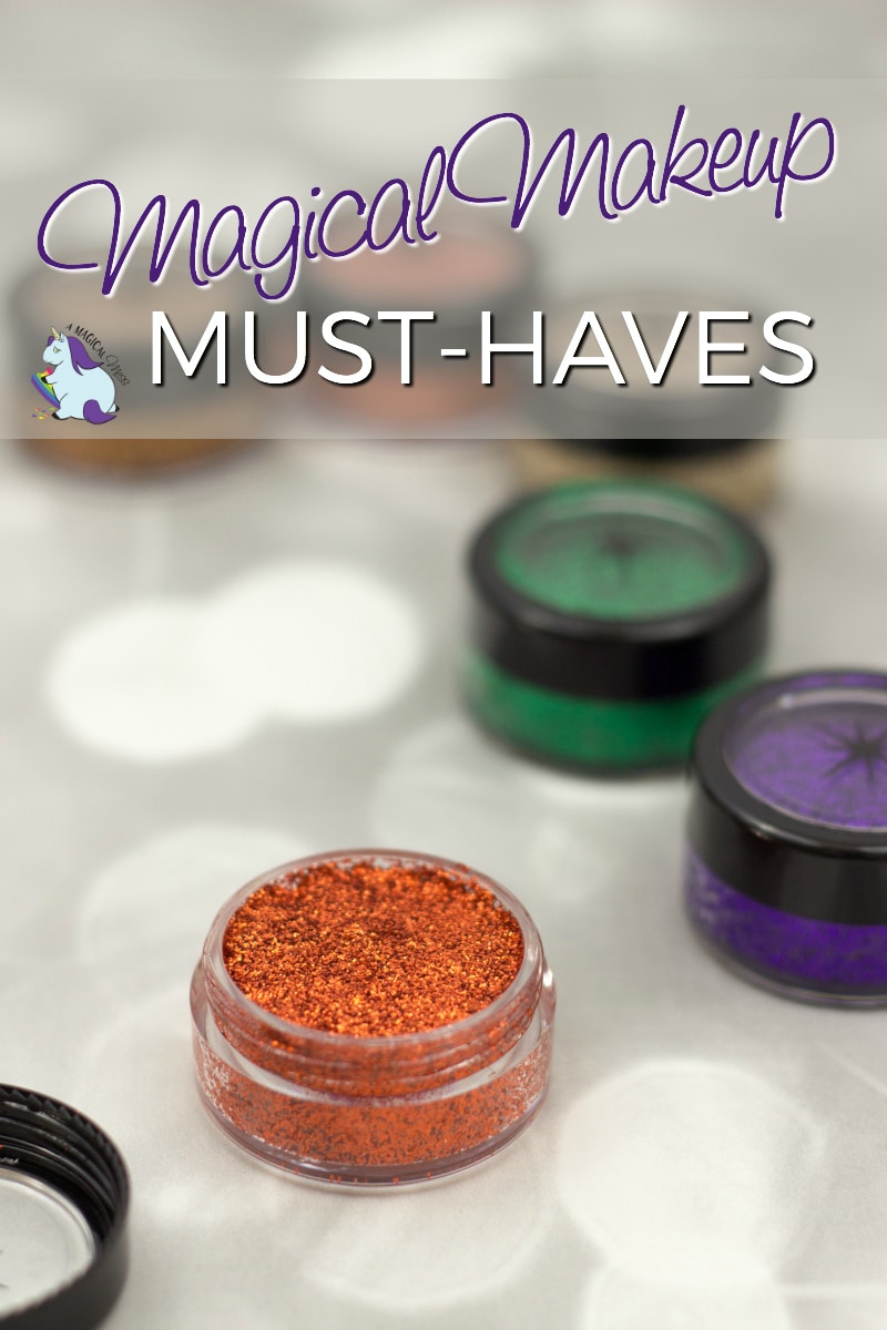 A container of orange glittery eyeshadow next to jars of green and purple. 