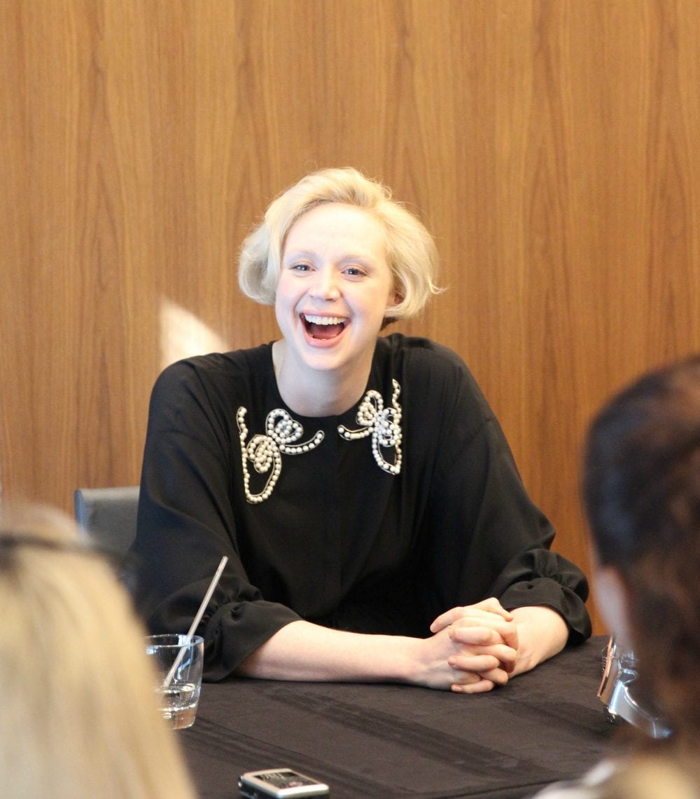 Gwendoline Christie smiling during an interview. 