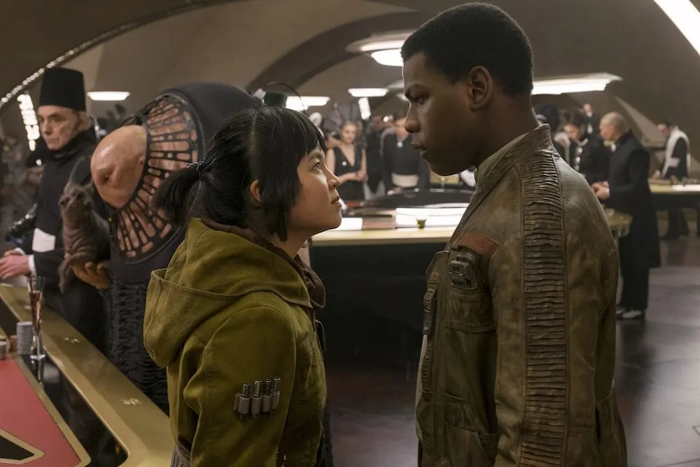 Star Wars: The Last Jedi L to R: Rose (Kelly Marie Tran) and Finn (John Boyega) Photo: David James ©2017 Lucasfilm Ltd. All Rights Reserved.