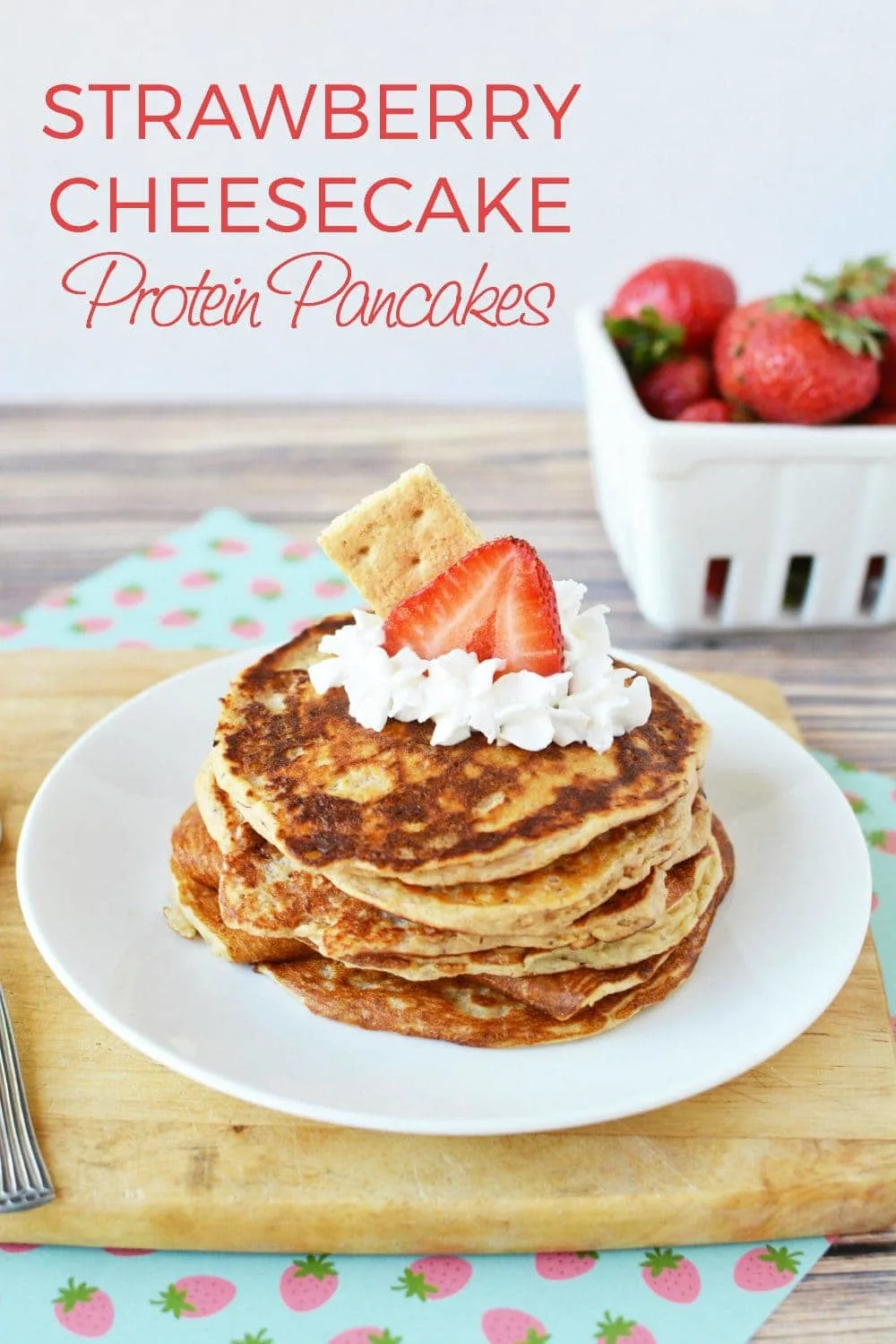 Pancakes with whipped cream and strawberry on top