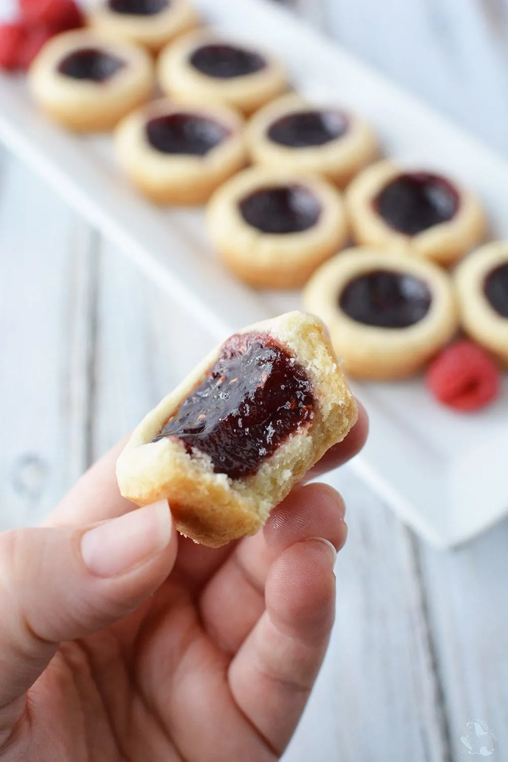 Mini raspberry shortbread tarts on a table. 