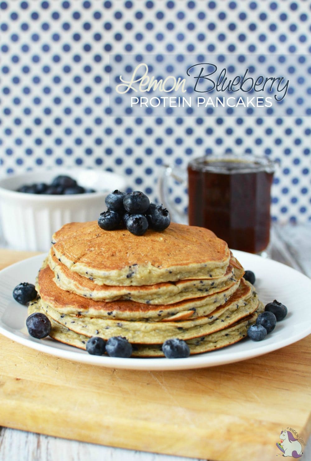 Lemon blueberry protein pancakes on a plate next to syrup. 