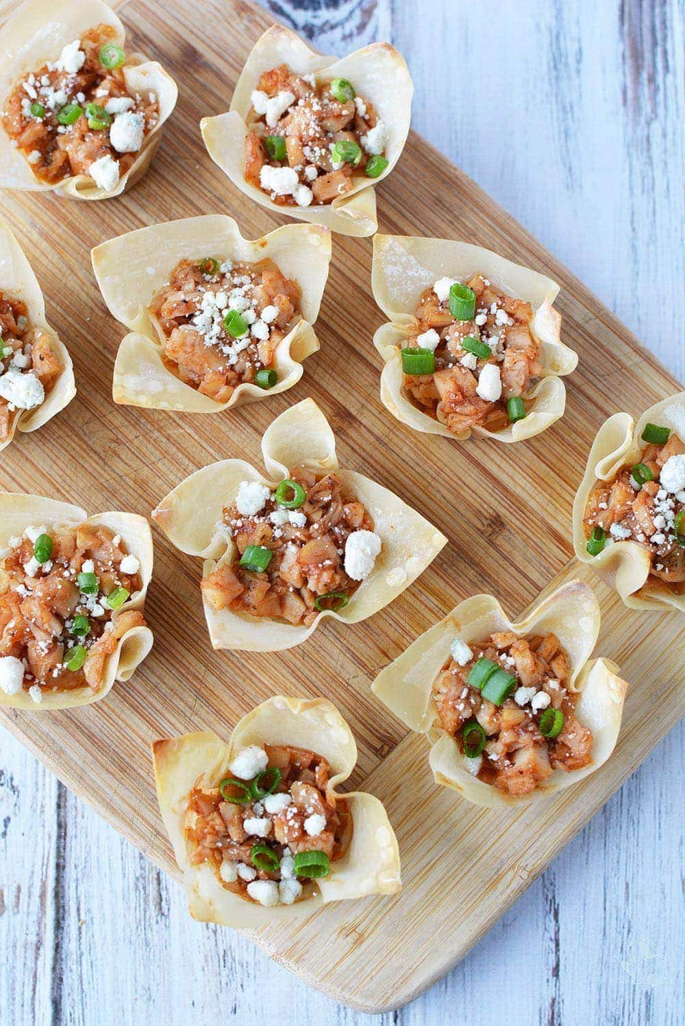 Chicken Wonton Cups Appetizers on a cutting board.