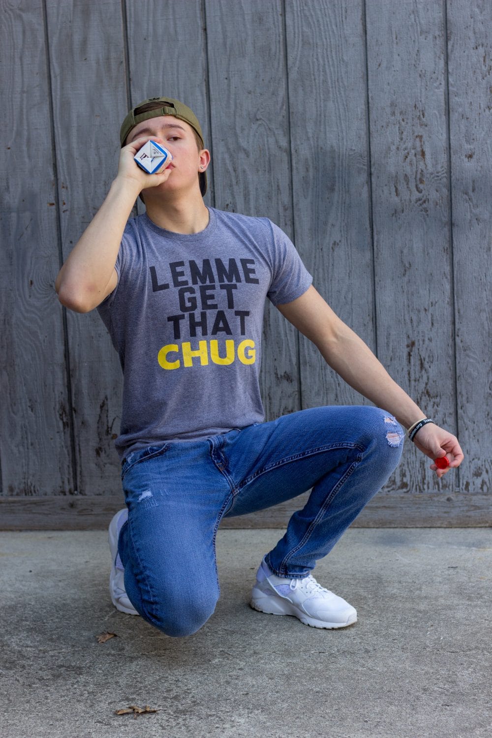 Teen boy in a shirt that says "Lemme get that chug."