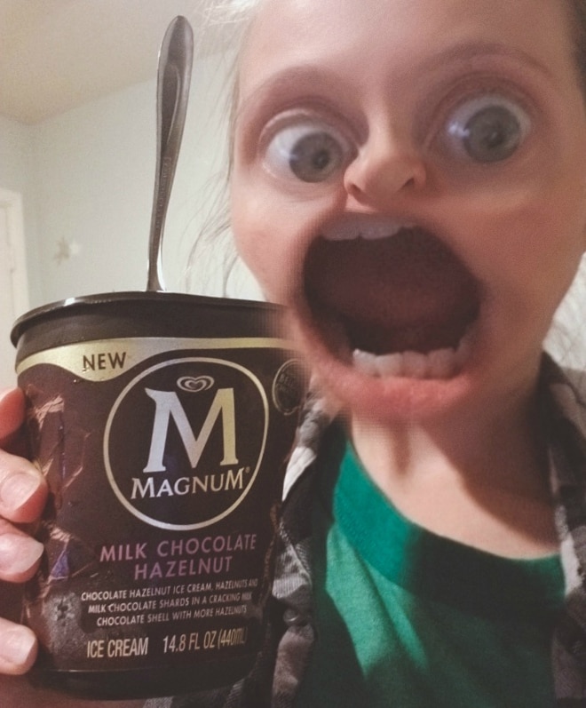 Large mouth Snapchat filter next to a pint of Magnum ice cream