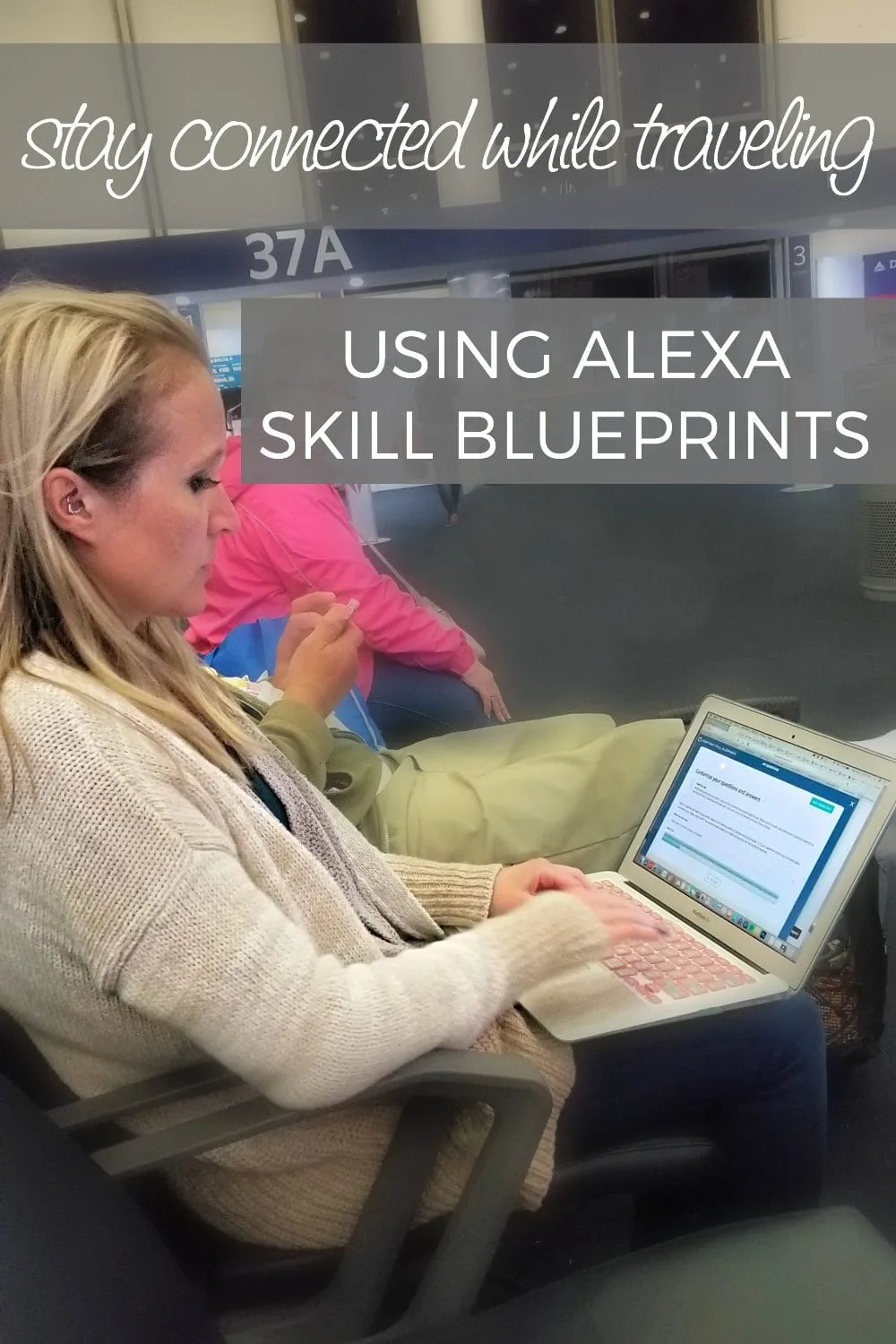 Girl in an airport typing on her laptop. 