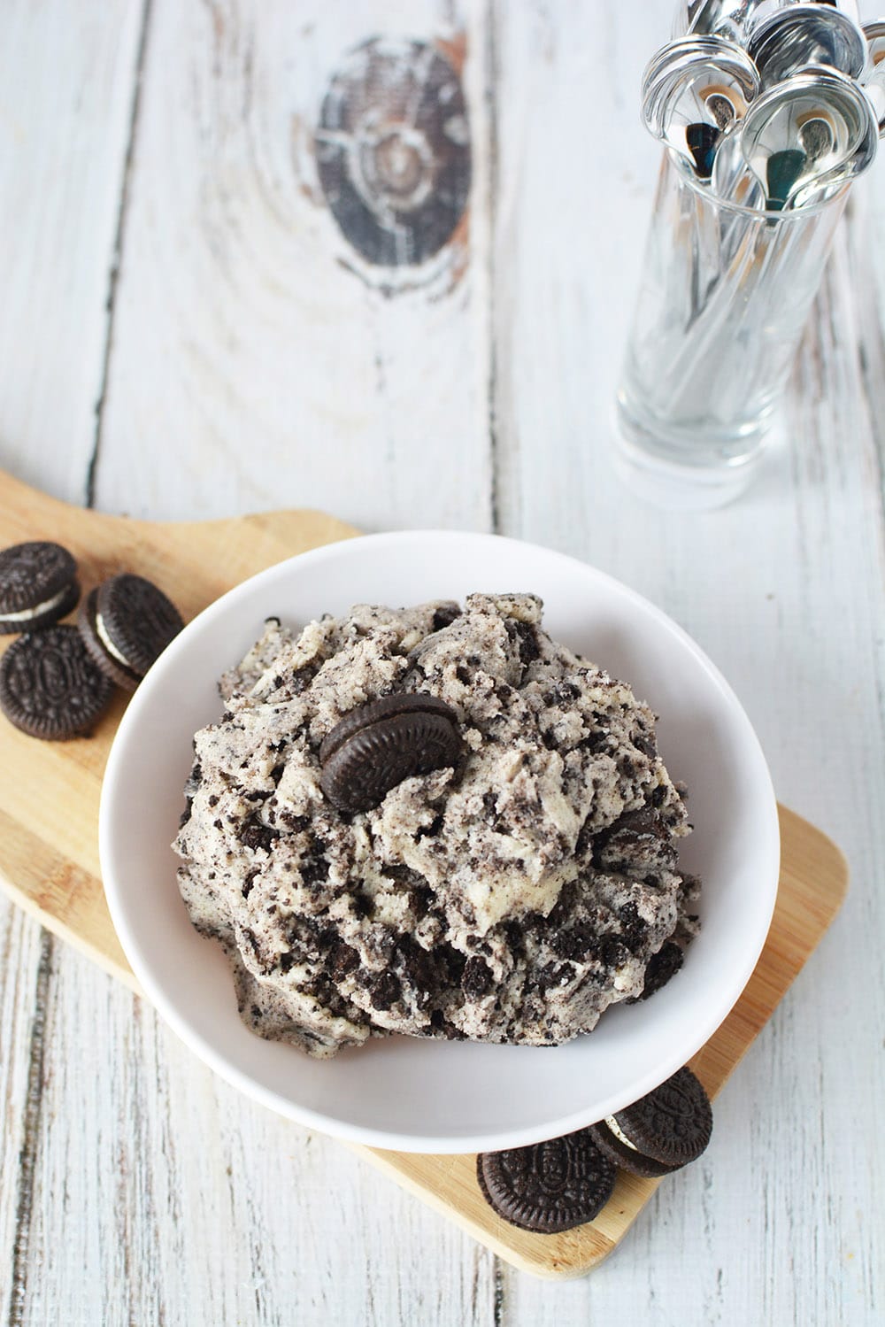 Oreo cookie dough dip in a bowl next to mini oreos and spoons. 