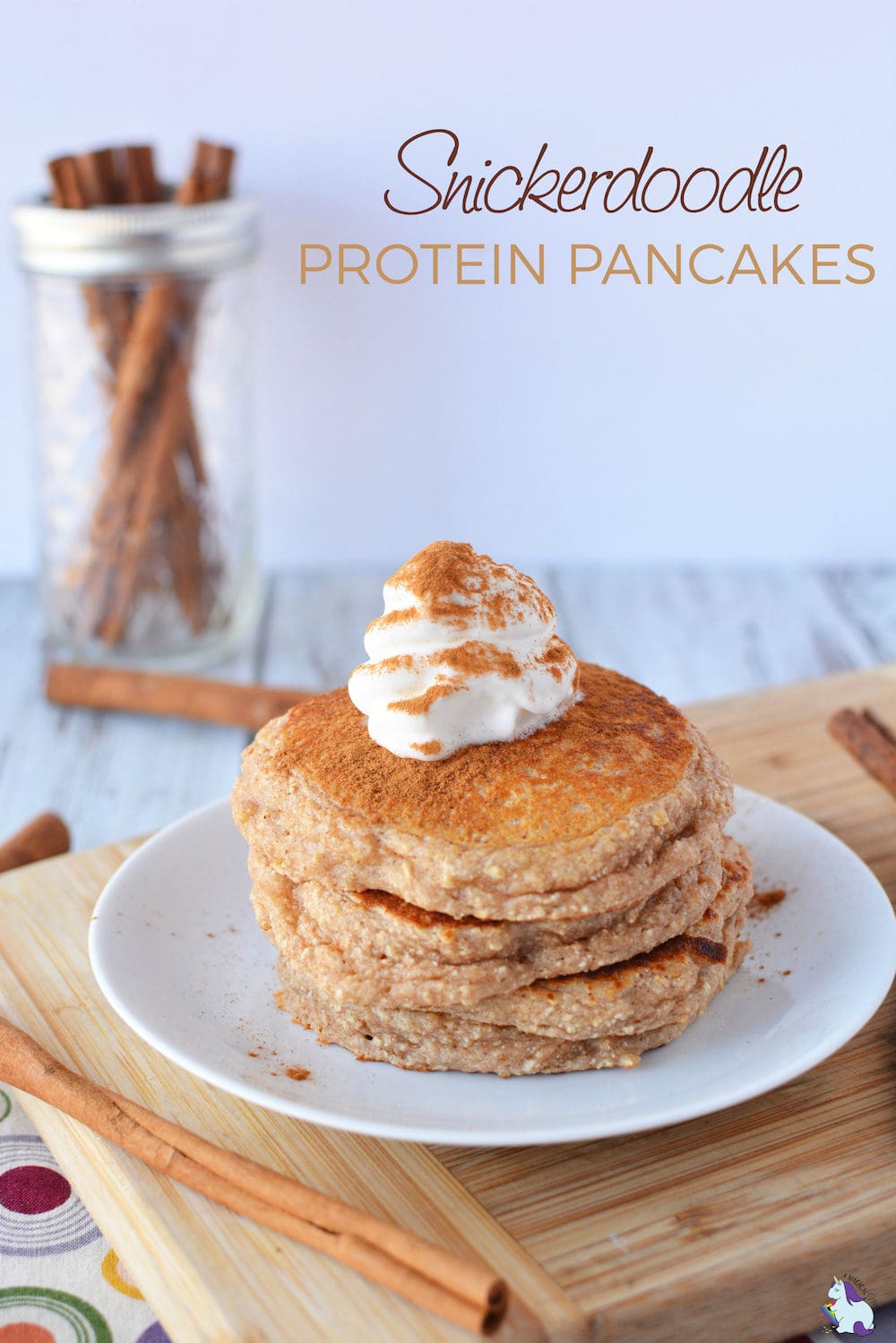 Snickerdoodle protein pancakes with whipped cream and cinnamon on top