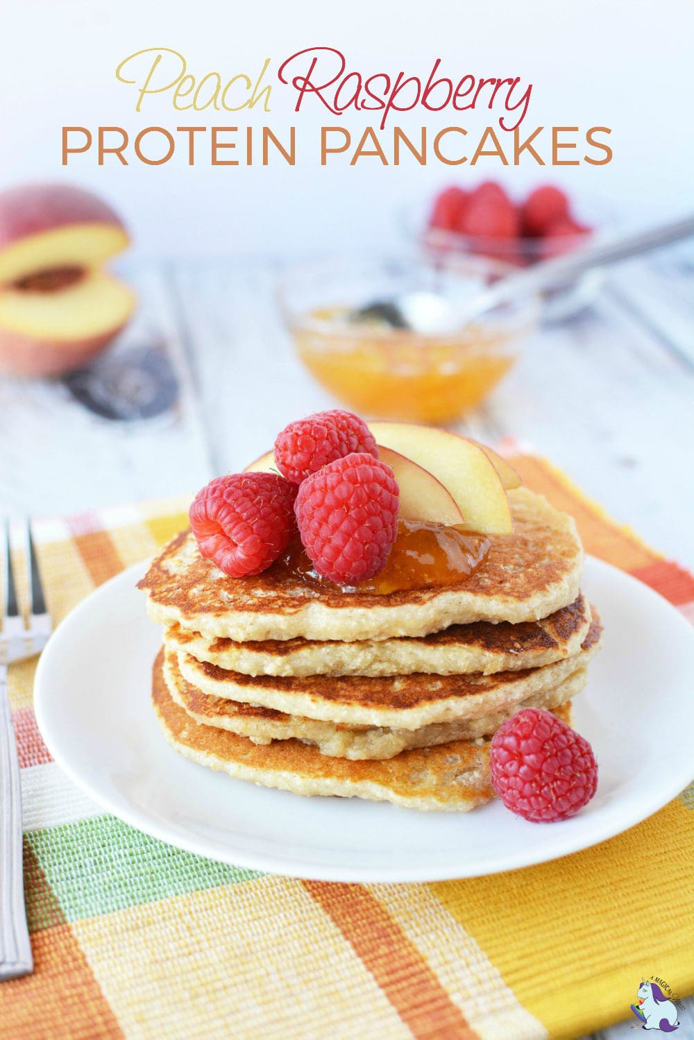 Pancakes topped with peaches and raspberry on a plate. 