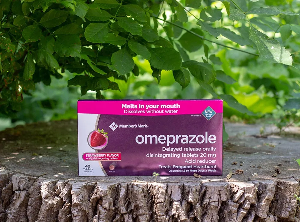 Box of omeprazole on a tree stump. 