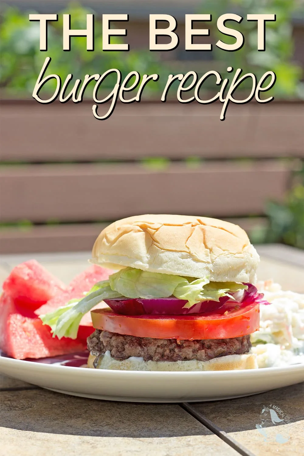 A burger on a plate with coleslaw and watermelon. 