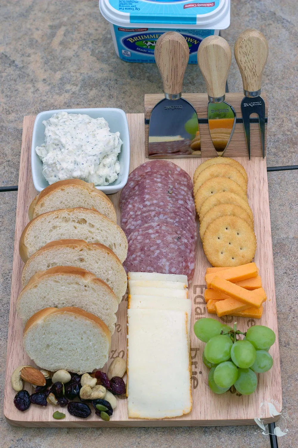 Meat and cheese board with garlic spread for bread