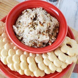 Butter pecan cookie dough in a bowl surrounded but butter cookies on a dish