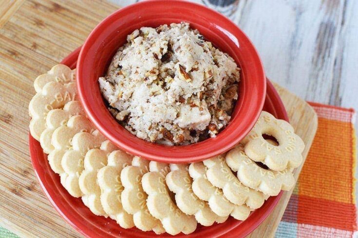 Butter pecan cookie dough in a bowl surrounded but butter cookies on a dish