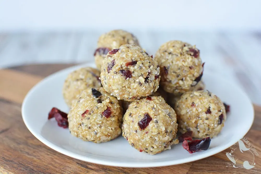 Energy balls with cranberry stacked on a plate. 