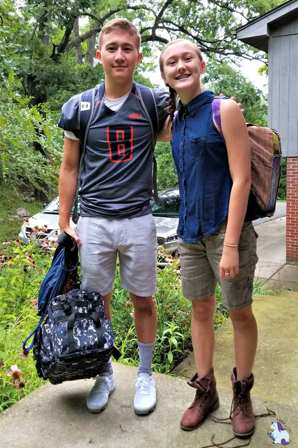 Adam and Chesney standing outside with backpacks before school. 