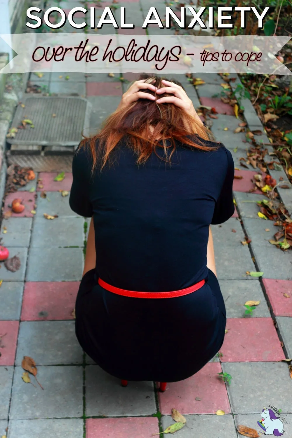 A girl sitting on a sidewalk looking anxious.