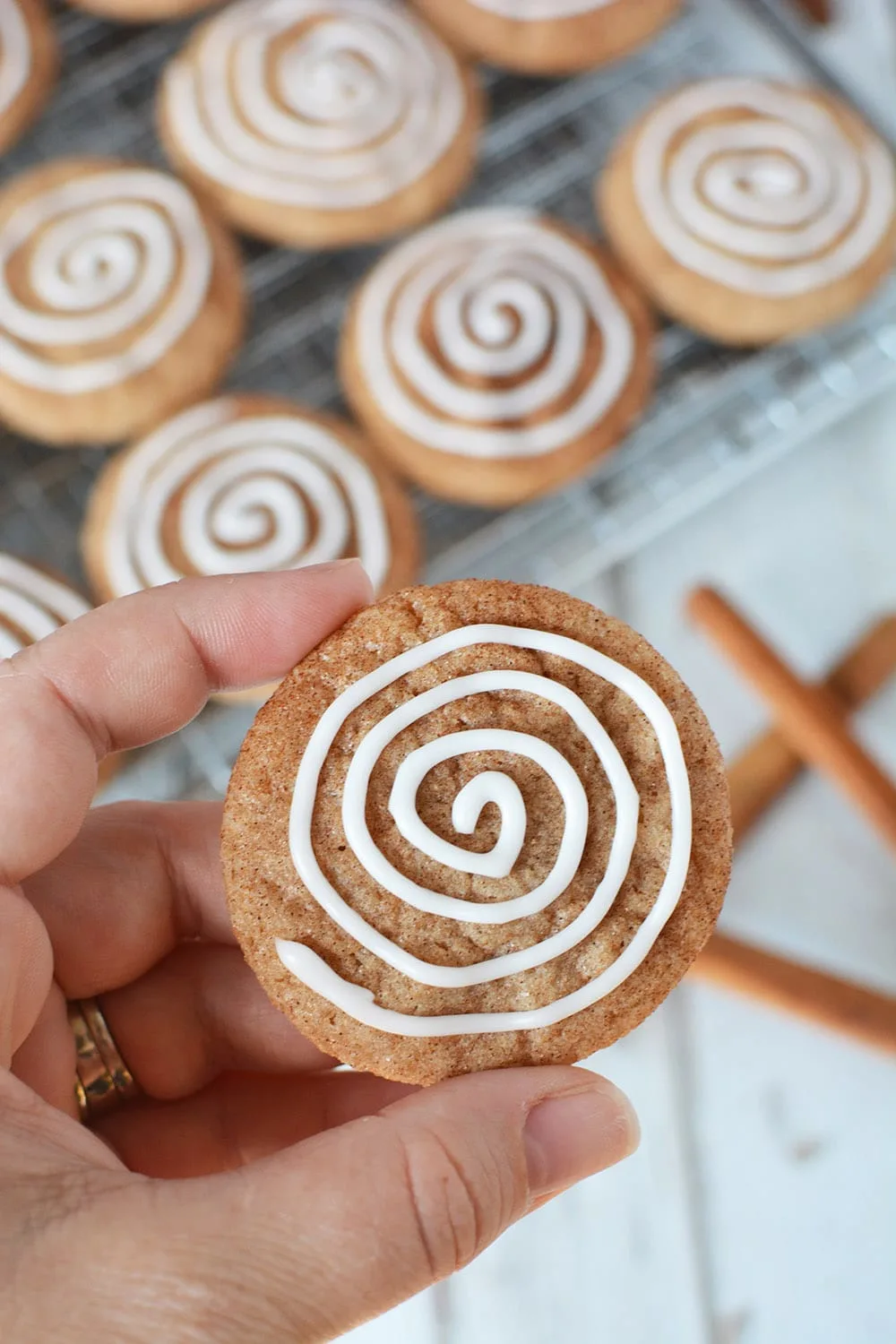 Holding a cinnamon roll cookie to show the detail